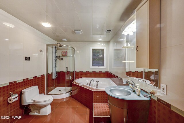 full bathroom featuring vanity, plus walk in shower, tile patterned floors, toilet, and tile walls