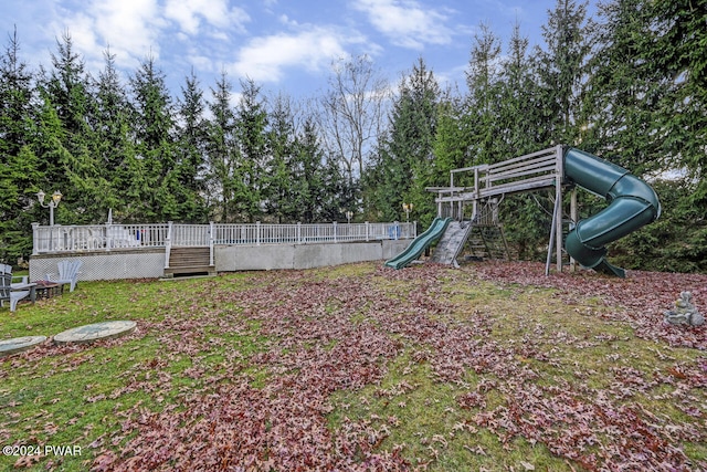 view of yard with a deck and a playground