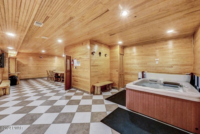 misc room featuring wooden walls, wood ceiling, and a hot tub