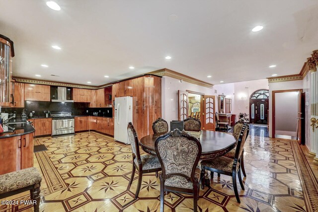 dining space featuring crown molding, sink, and french doors