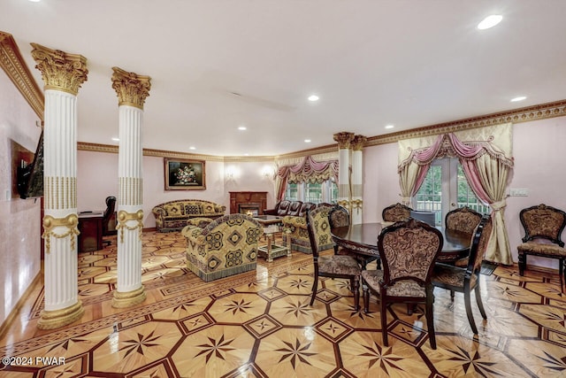 dining area with decorative columns and ornamental molding