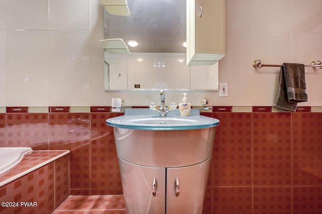 bathroom with tile patterned flooring, vanity, and tile walls