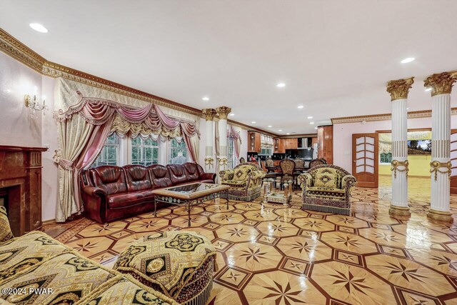 living room with ornate columns and crown molding