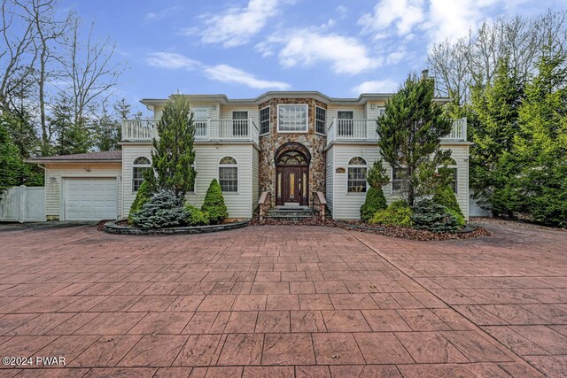 view of front of property with a balcony and a garage