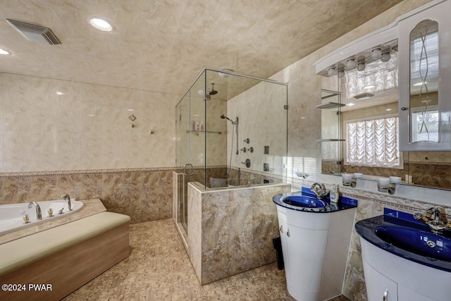 bathroom with vanity, plus walk in shower, and tile walls