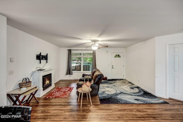 living room featuring hardwood / wood-style floors and ceiling fan