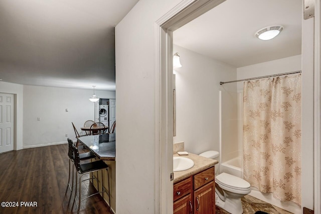 full bathroom featuring shower / bathtub combination with curtain, stacked washer / dryer, wood-type flooring, toilet, and vanity