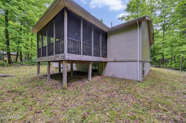 rear view of house featuring a sunroom