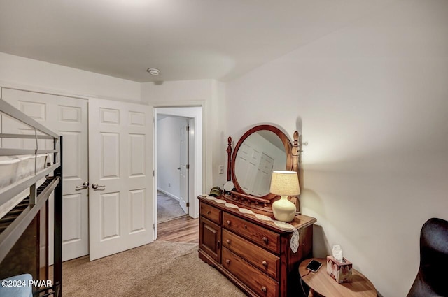 bedroom with light carpet and a closet