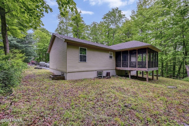 back of property with a sunroom