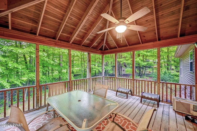 unfurnished sunroom featuring wood ceiling, ceiling fan, and lofted ceiling with beams