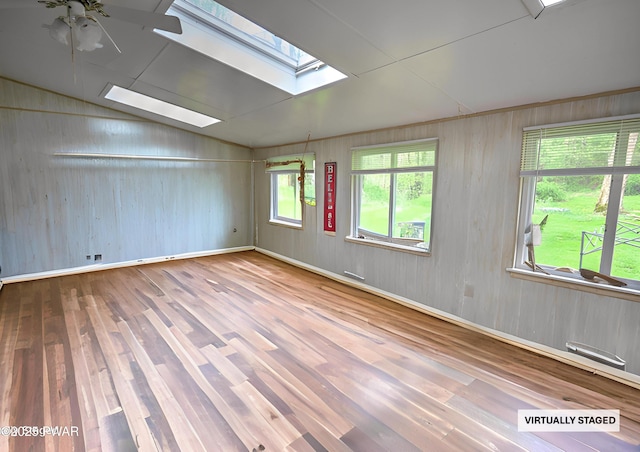 162 Plank Rd, Beach Lake, PA 18405 - unfurnished room with a skylight, wood finished floors, wooden walls, lofted ceiling, and ceiling fan