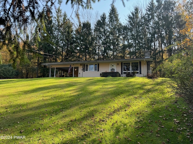 exterior space featuring a yard and a carport