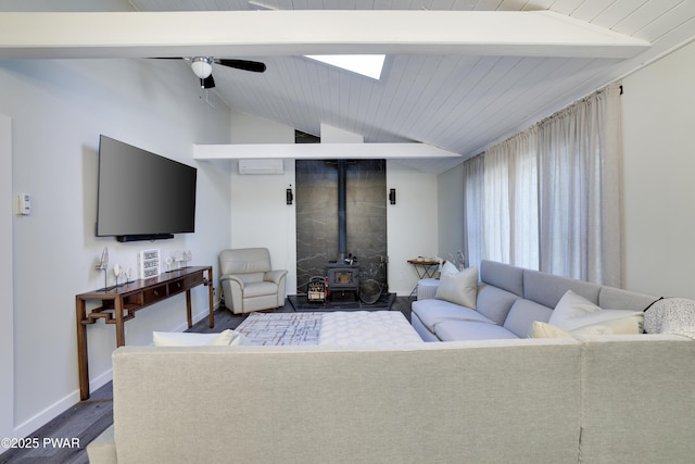 439 Gold Finch Rd, Bushkill, PA 18324 - living area featuring a wood stove, dark wood finished floors, a ceiling fan, and baseboards