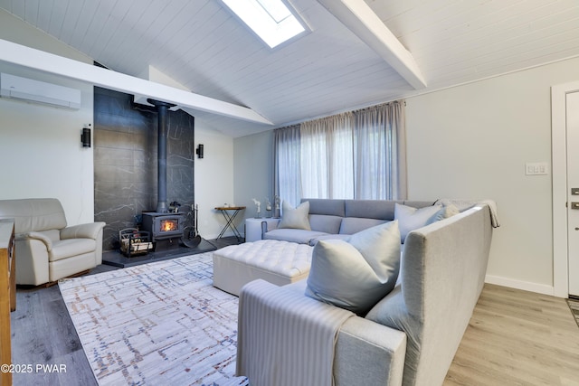439 Gold Finch Rd, Bushkill, PA 18324 - living room featuring a wall unit AC, light wood finished floors, a wood stove, baseboards, and a skylight
