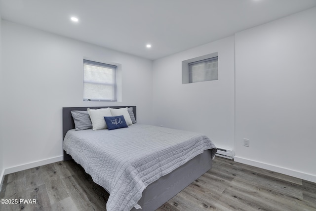 439 Gold Finch Rd, Bushkill, PA 18324 - bedroom with wood finished floors, recessed lighting, baseboard heating, and baseboards