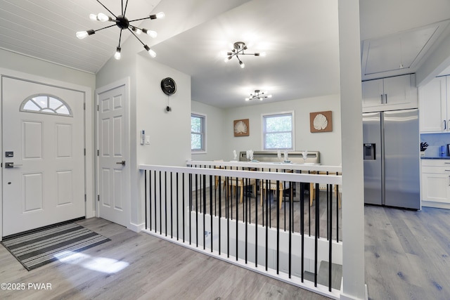 439 Gold Finch Rd, Bushkill, PA 18324 - entryway featuring light wood-style flooring, a chandelier, and lofted ceiling