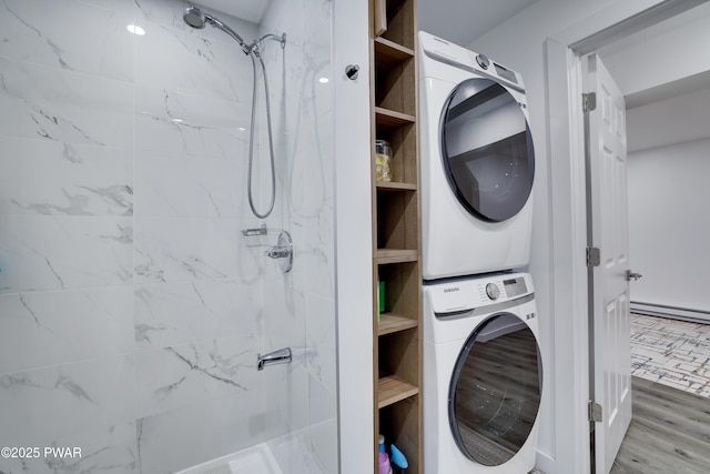 439 Gold Finch Rd, Bushkill, PA 18324 - washroom with stacked washer / drying machine, baseboard heating, and wood finished floors