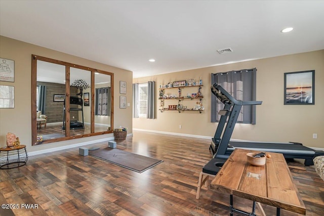 exercise area with recessed lighting, visible vents, baseboards, and wood finished floors