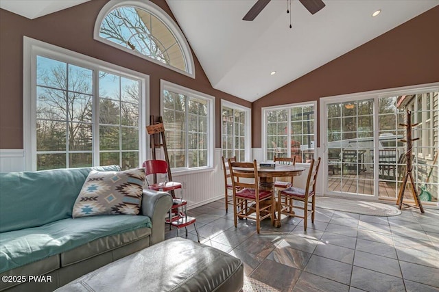 sunroom / solarium with a wealth of natural light, ceiling fan, and vaulted ceiling