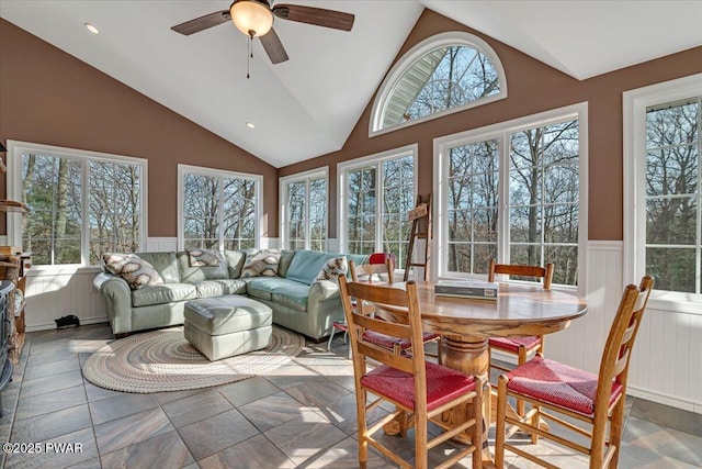 sunroom featuring lofted ceiling, a healthy amount of sunlight, and ceiling fan