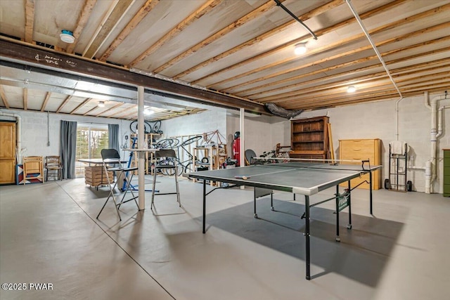 rec room featuring concrete floors