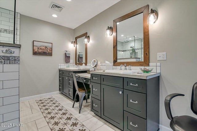 bathroom featuring a sink, two vanities, visible vents, and tiled shower