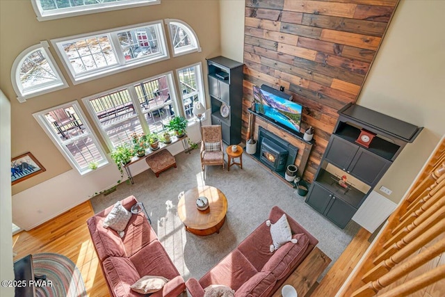 living room featuring a glass covered fireplace and a towering ceiling