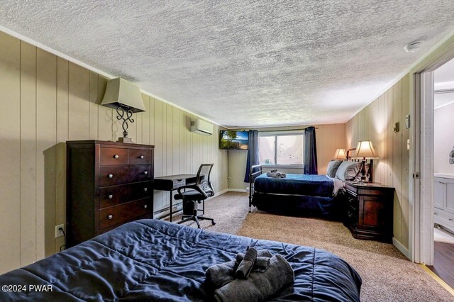 bedroom with carpet, wood walls, and an AC wall unit