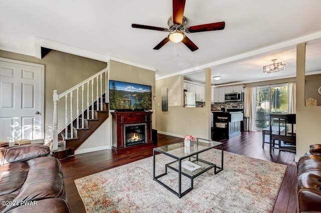 living room featuring ceiling fan and dark hardwood / wood-style floors