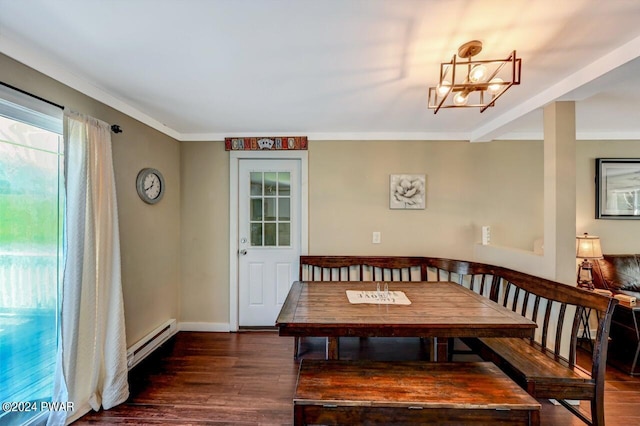 dining room featuring a chandelier, dark wood-type flooring, a baseboard radiator, and ornamental molding