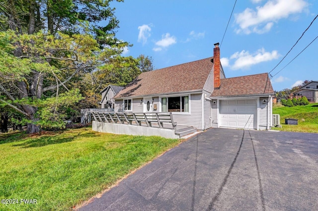 view of front of house with a front lawn, a deck, and a garage