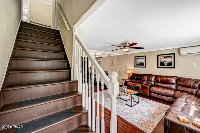 stairway featuring hardwood / wood-style floors, ceiling fan with notable chandelier, and a wall unit AC