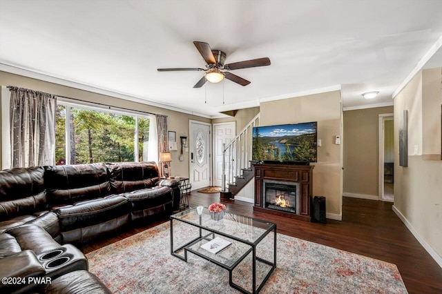 living room with crown molding, ceiling fan, and dark hardwood / wood-style floors