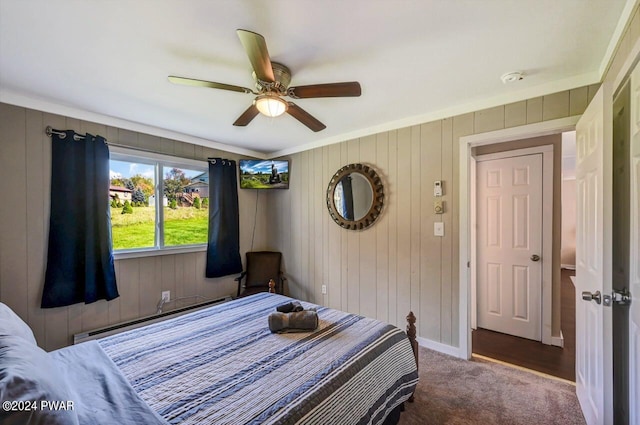 bedroom featuring carpet floors, ceiling fan, and wood walls