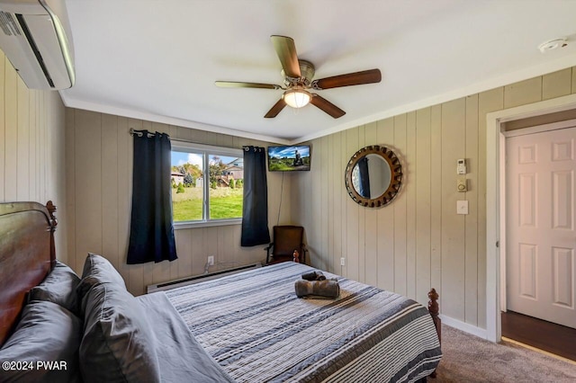 carpeted bedroom with ceiling fan, a baseboard heating unit, an AC wall unit, wood walls, and ornamental molding