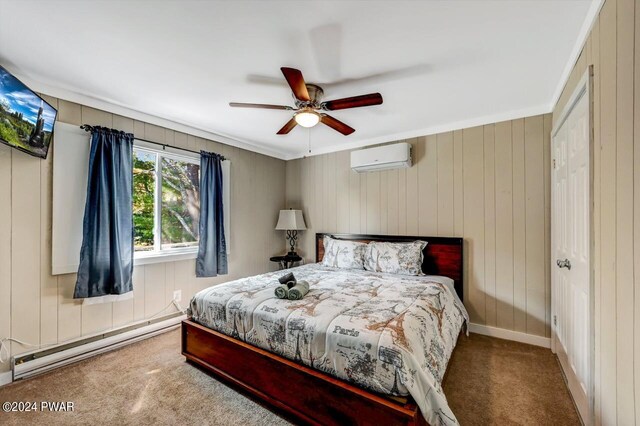 bedroom with carpet flooring, ceiling fan, baseboard heating, a wall unit AC, and crown molding