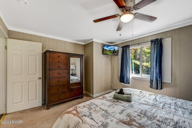 bedroom with light carpet, ceiling fan, and ornamental molding