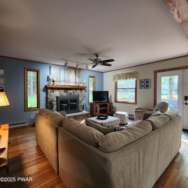 101 Deer Run, Greentown, PA 18451 - living room featuring a baseboard radiator, wood-type flooring, a ceiling fan, and a stone fireplace