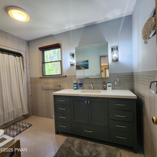 101 Deer Run, Greentown, PA 18451 - full bathroom featuring tile walls, tile patterned flooring, vanity, wainscoting, and a shower with shower curtain