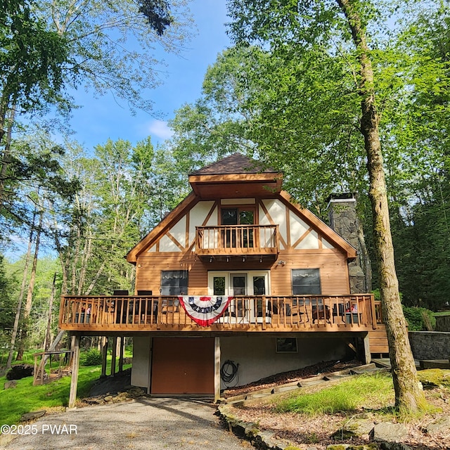 101 Deer Run, Greentown, PA 18451 - view of front facade featuring a deck, an attached garage, a chimney, and driveway
