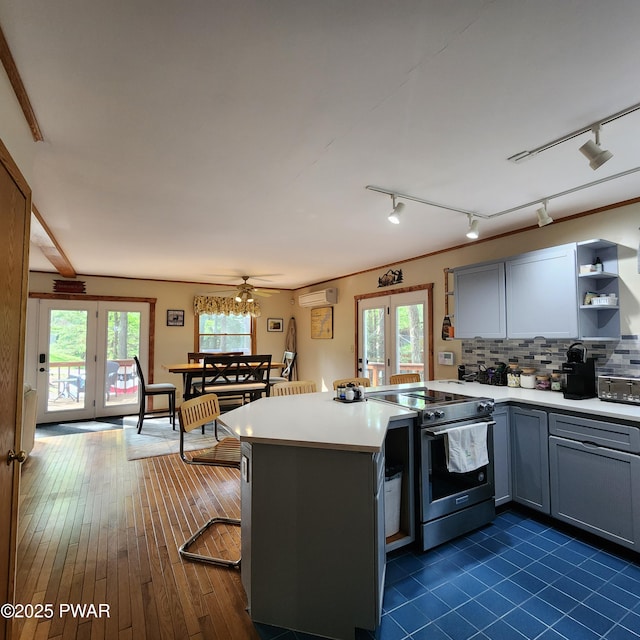 101 Deer Run, Greentown, PA 18451 - kitchen with stainless steel electric range, a peninsula, light countertops, and healthy amount of natural light