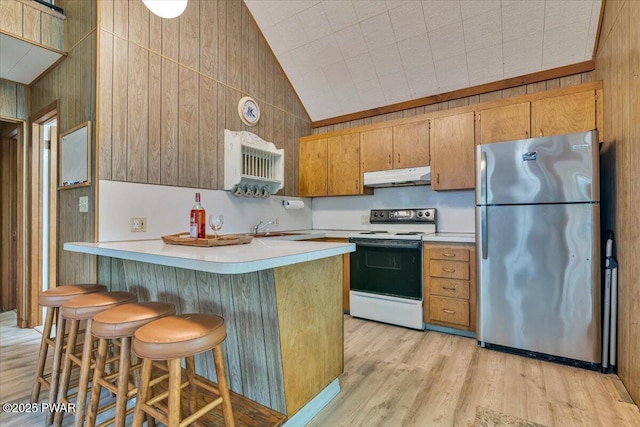 1474 Lakeland Dr, Lake Ariel, PA 18436 - kitchen featuring freestanding refrigerator, white electric stove, under cabinet range hood, light countertops, and lofted ceiling