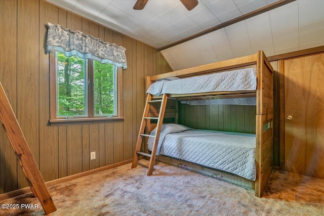 1474 Lakeland Dr, Lake Ariel, PA 18436 - bedroom with carpet floors, wooden walls, vaulted ceiling, and ceiling fan