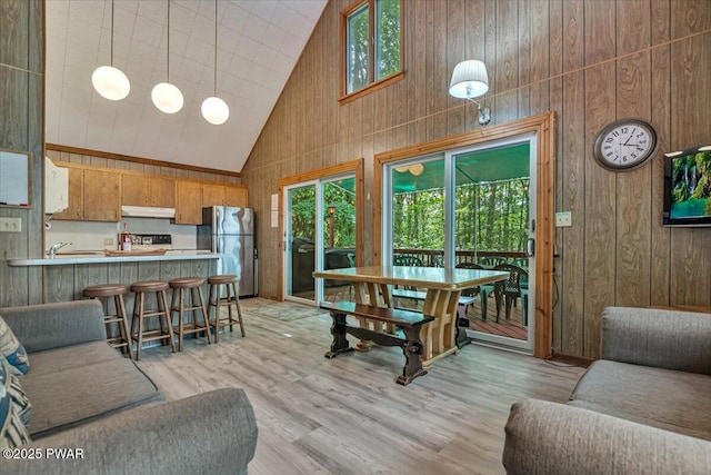 1474 Lakeland Dr, Lake Ariel, PA 18436 - living room featuring high vaulted ceiling, wood walls, and light wood-style floors