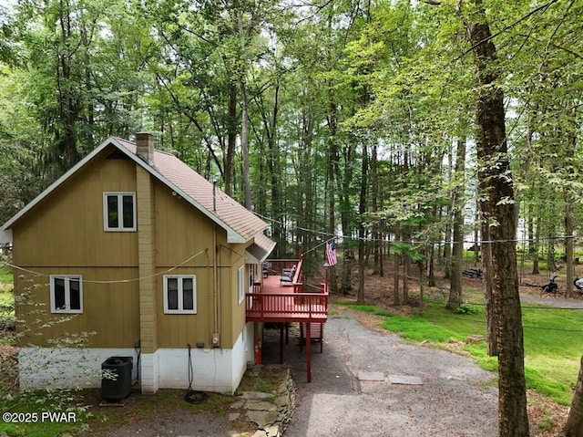 1474 Lakeland Dr, Lake Ariel, PA 18436 - view of property exterior with a wooden deck, a chimney, and a shingled roof