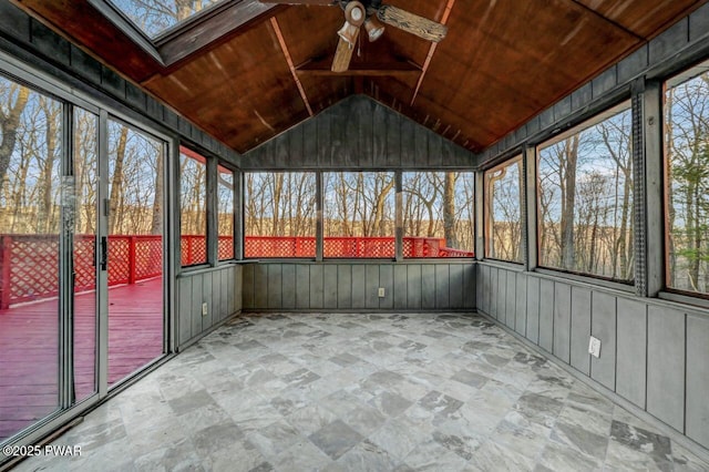 unfurnished sunroom featuring lofted ceiling with skylight, wooden ceiling, and ceiling fan