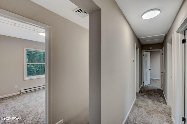 hallway featuring light colored carpet and baseboard heating