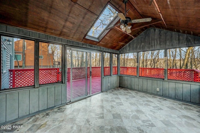 unfurnished sunroom featuring wood ceiling, ceiling fan, and vaulted ceiling with skylight