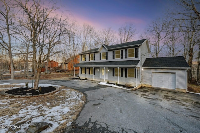 view of front facade with a garage and covered porch